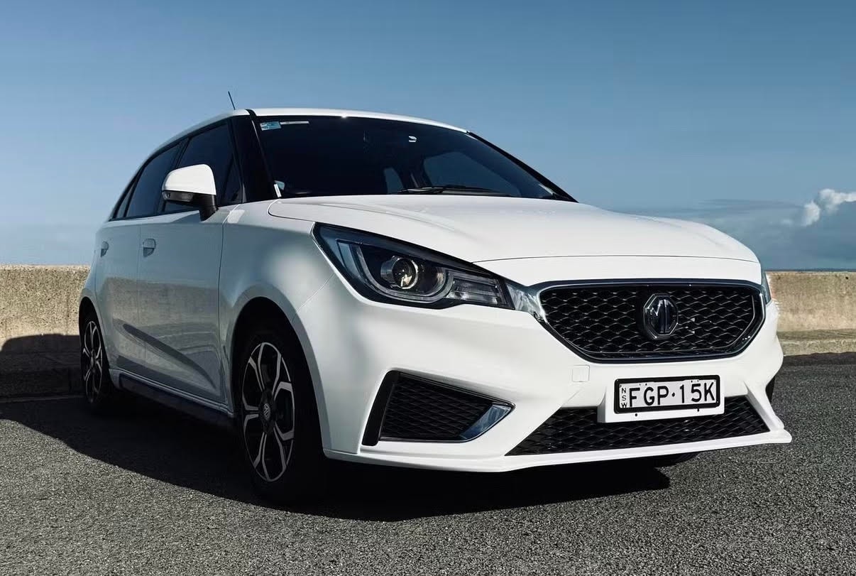 MG3 compact car parked on coastal road — Luxroo rental fleet